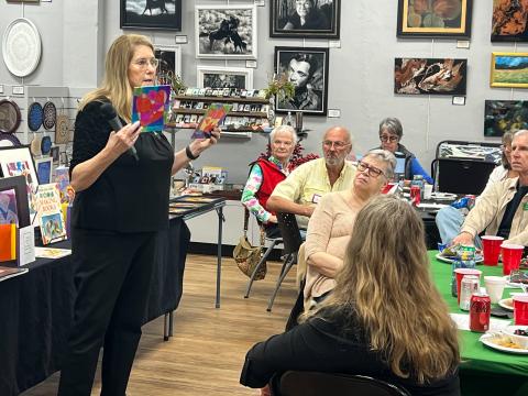 Laura Hunter-Null, a 30-year arts educator, presents some of the artwork and the lessons used in the free art program for students in grades 1-3 to the adult members of the Gateway Art Gallery. (COURTESY GATEWAY ART GALLERY)