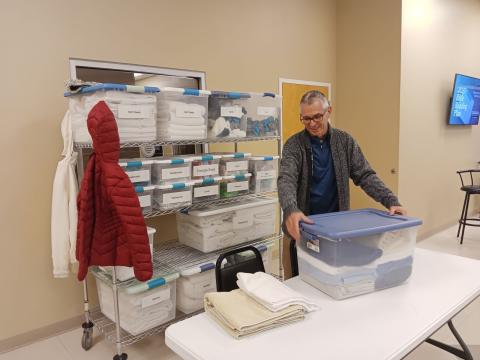 Mike Tatem, Pastor of Parkview Baptist Church, grabs a handful of supplies that will be used in the church’s cold weather shelter on Wednesday before opening the shelter for the evening. (TONY BRITT/Lake City Reporter)