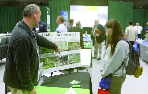 Bryon Wuczynski (left), an Osiris 9 representative, shows a list of recent projects to April Thomas with the Florida Department of Transportation. Osiris 9 helped develop the concept for the U.S. Highway 41 and Interstate 75 interchange project that will be starting soon in Ellisville. (TONY BRITT/Lake City Reporter)
