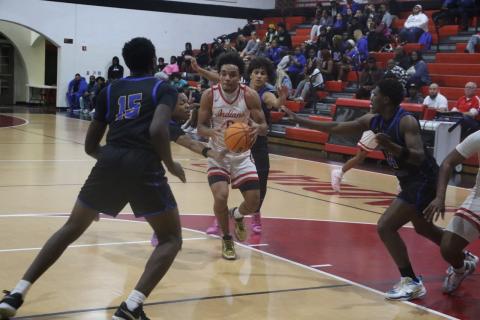 Fort White guard Tafari Moe gets surrounded by four Newberry defenders on his way to the rim in Thursday’s loss. (MORGAN MCMULLEN/Lake City Reporter)