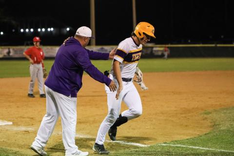 Columbia's Ayden Phillips is congratulated by coach Chris Howard after hitting a home run last season. (FILE)