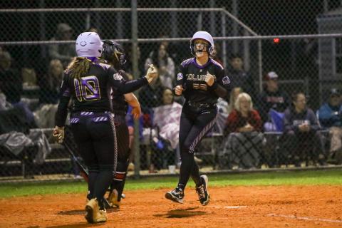Columbia catcher Emily Delgado celebrates as she scores to tie the game in the fifth inning of Monday's season opener against Fort White. (BRENT KUYKENDALL/Lake City Reporter)