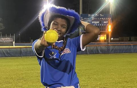 Branford's Mallory Blue shows off her grand slam ball after the Buccaneers defeated Middleburg on Tuesday night. (COURTESY)