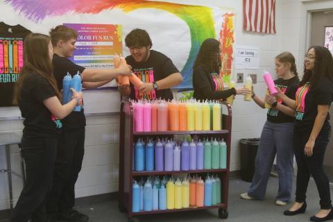 Fort White National Honor Society members Jada Knight (from left), Jack Schroader, Juan Bustamante, Arelis Maldonado, Sarah Heeke and Anais Maldonado prepare and inventory powder for the club’s color fun run which takes place on Saturday at Arrowhead Stadium. (TONY BRITT/Lake City Reporter)