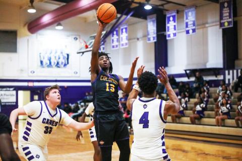 Columbia forward Zavian Douglas shoots over Gainesville forward Cornelius White on Jan. 23. (BRENT KUYKENDALL/Lake City Reporter)