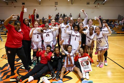 The Fort White girls basketball team celebrates with the District 6-R trophy after defeating Trenton on Saturday night. (JACK HOWDESHELL/Lake City Reporter)