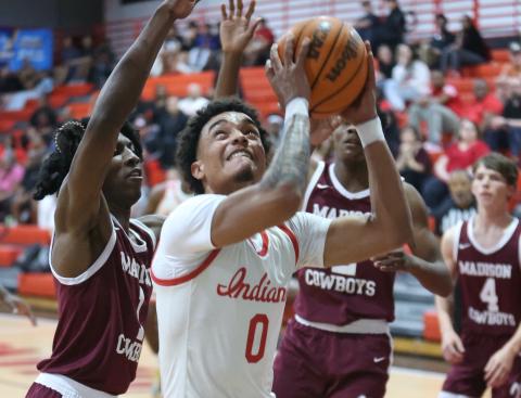Fort White guard Tafari Moe tries to get off a shot while surrounded by Madison County's defense during Wednesday's Region 3-R semifinal. (PAUL BUCHANAN/Lake City Reporter)