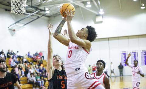 Fort White guard Tafari Moe shoots while defended by Trenton guard Mason VunCannon during the District 6-R championship on Friday. (BRENT KUYKENDALL/Lake City Reporter)