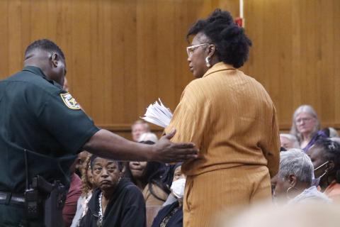 White Springs Town Manager Vanessa George is escorted out of the Hamilton County Courthouse courtoom Monday during the county’s legislative delegation hearing. George was removed after repeatedly interrupting Sen. Corey Simon. (JAMIE WACHTER/Lake City Reporter)