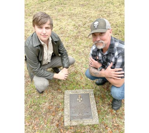 Todd Denmark (right) and his son, Jackson, visit their ancestor’s grave in St. Augustine as part of a trip to connect with their family’s history. (COURTESY)