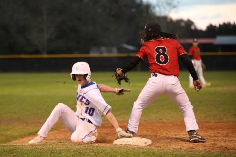 Branford's Patrick Williams slides safely into third base against Fort White on March 10. (BRENT KUYKENDALL/Lake City Reporter)