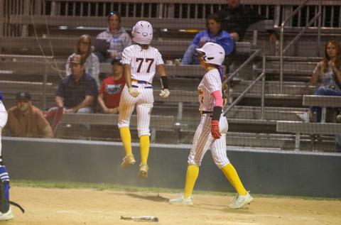 Columbia left fielder Sakiya Merriex jumps after crossing home plate with the game-winning run against Keystone Heights Friday night. Shortstop Lillyenne Mayhew, who had also scored on the play, celebrates alongside Merriex. (BRENT KUYKENDALL/Lake City Reporter)