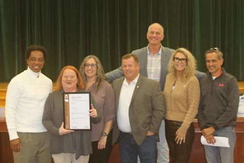 Kim Goldsmith (holding award) and Michelle Moore (to her left) show off the Columbia County Tourist Development Council’s Adrian Award received last year. The TDC received another award this year in the international sales and marketing contest with more than 800 entries alongside other officials. (FILE)