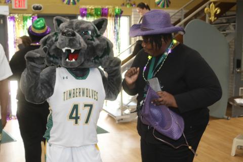 Bolts, the Florida Gateway College mascot, and Shawana Wilson dance to Zydeco music in the college’s student center on Tuesday during a Mardi Gras celebration. (TONY BRITT/Lake City Reporter)