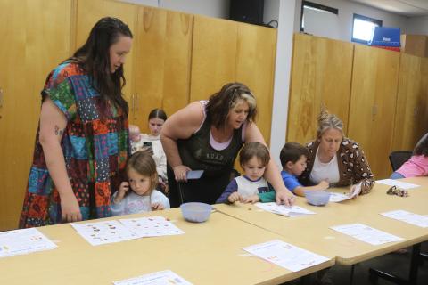 Alexa DeMarco (standing left) and Tracy Lock (standing right) help Cyrilla Matthews, 4, and Atlas Matthews, 5, during the workshop. (TONY BRITT/Lake City Reporter)