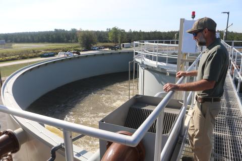 City of Lake City Wastewater Director Cody Pridgeon looks in on a tank of untreated wastewater Wednesday morning at the North Florida Mega Industrial Park wastewater plant, which recently started operations. (TONY BRITT/Lake City Reporter)