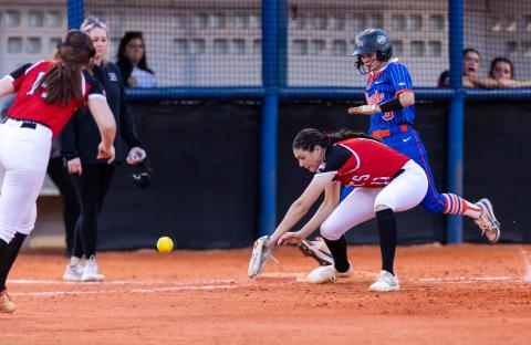 Lafayette second baseman Clara Knight (14) makes a throwing error to allow Branford's Cloey Criggall to reach first base safely Thursday night. (JACK HOWDESHELL/Lake City Reporter)