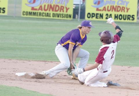 North Marion’s Tucker Jones slides in safely at second base as Columbia shortstop Logan Brooks attempts to field a throw Friday night. (MORGAN MCMULLEN/Lake City Reporter)