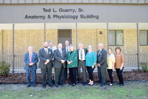 Amy Guerry (middle) is joined by members of the Gateway-Forest Lawn Funeral Home family as they stand in front of the newly-named Ted L. Guerry, Sr. Anatomy & Physiology Building on the Florida Gateway College campus. (COURTESY FLORIDA GATEWAY COLLEGE)