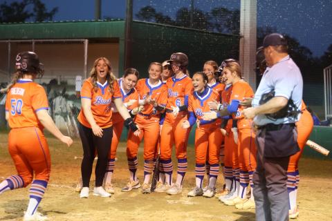 Branford's softball team greets Ellie Frierson at home plate after Frierson hit a home run against Suwannee on Friday night. (PAUL BUCHANAN/Lake City Reporter)