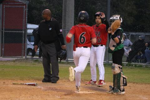 Fort White's Matthew Pitts (6) is greeted at home plate by junior Davic Kasper during Monday's 16-1 win over Ocala Christian. (MORGAN MCMULLEN/Lake City Reporter)