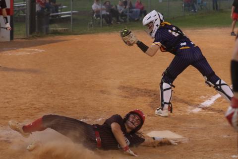 Williston’s Brooklyn Bertrand slides safely into home plate ahead of the tag from Columbia catcher Emily Delgado in the Tigers’ 11-0 loss Tuesday. (MORGAN MCMULLEN/Lake City Reporter)