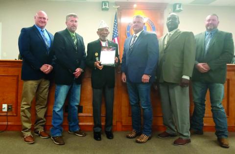 Command Sergeant Major William Smith (third from left) presents a plaque designating Suwannee County as a Purple Heart County to Commissioners Don Hale (from left), Travis Land, Franklin White, Maurice Perkins and Leo Mobley at the board’s March 4 meeting. (COURTESY)