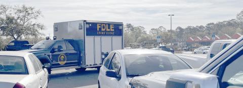 A Florida Department of Law Enforcement Crime Scene vehicle pulls out of the Home Depot parking lot Tuesday morning. FDLE helped process the scene of a 'suspicious' death in a vehicle at the Lake City store. (JAMIE WACHTER/Lake City Reporter)
