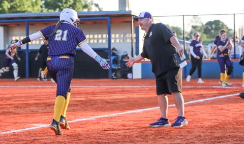 Columbia pitcher Harleigh Price high fives coach Joe Saucier as she rounds third base after hitting a home run against Branford on Tuesday. (BRENT KUYKENDALL/Lake City Reporter)