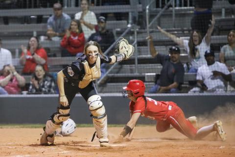 Middleburg third baseman KK Hagan slides under the tag of Columbia catcher Emily Delgado to score the go-ahead run in the seventh inning Thursday. The Broncos scored five runs in the inning to win 8-3. (BRENT KUYKENDALL/Lake City Reporter)