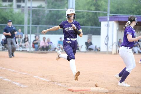 Columbia catcher Emily Delgado is thrown out at first base during Tuesday's loss to Gainesville. (BRENT KUYKENDALL/Lake City Reporter)