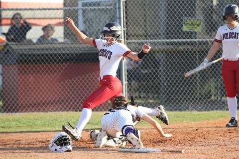 Columbia catcher Emily Delgado's tag isn't in time to stop one of Baker County's 10 runs on Thursday. (BRENT KUYKENDALL/Lake City Reporter)