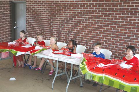 Quinny Shepple (from left), Cooper Shepple, Kahlani Kelley, Farrah Combs, Levi Powell and Ava Brown get ready to down some watermelon during the kids’ watermelon eating contest at the Rotary Club of Lake City’s downtown Independence Day event last year. (FILE)