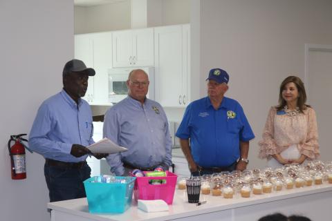 Fort White resident Marvin Brown (from left) details the history of the land on which the new Bethlehem Community Center sits during Tuesday’s ribbon cutting next to Columbia County Commissioners Rocky Ford and Everett Phillips as well as Lake City-Columbia County Chamber of Commerce Member Services Director Missy Hartley. (TONY BRITT/Lake City Reporter)