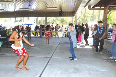 Members of Lana Kalias teach a group of Florida Gateway College students and faculty members how to properly do a Hula dance. (TONY BRITT/Lake City Reporter)