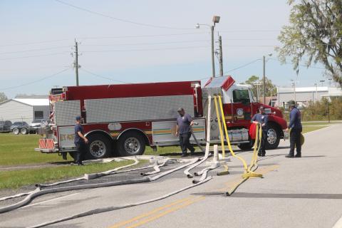 Columbia County Fire Rescue firefighters Joshua Chase, Ryan Jenkins, Cameron McCauley and Blake Heckman inspect a variety hoses as they prepare for a potential busy fire season. (TONY BRITT/Lake City Reporter)