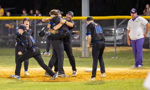 Branford players celebrates with coach Brian Tomlinson after defeating Union County 4-2 in the District 6-R semifinals Tuesday night. (JACK HOWDESHELL/Lake City Reporter)