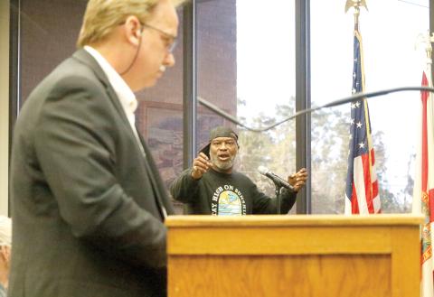 Darrell Bridgett points at Live Oak Development Manager George Curtis while questioning whether the city treats all developers equally during the Live Oak City Council meeting Tuesday. (JAMIE WACHTER/Lake City Reporter)