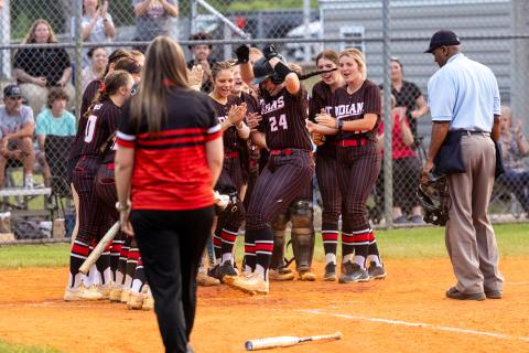 Fort White pitcher Kadence Compton celebrates at home plate with her teammates after hitting a two-run home run during Tuesday's 3-1 win over Suwannee. (JACK HOWDESHELL/Lake City Reporter)