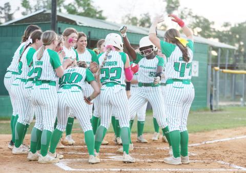 Suwannee outfielder Brianna Woods celebrates at home plate with her teammates after hitting a solo home run against Fort White on Friday. (PAUL BUCHANAN/Lake City Reporter)