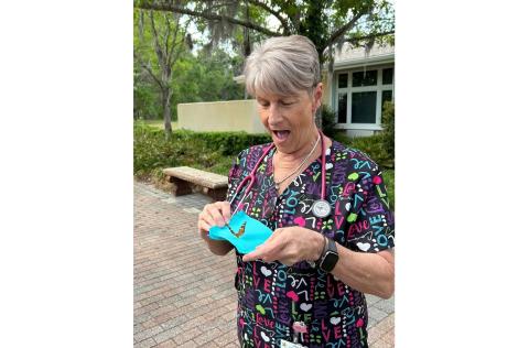 Haven Hospice registered nurse Cindy Romero readies to release one of the butterflies in the Butterfly Memorial Program event Thursday. (COURTESY)