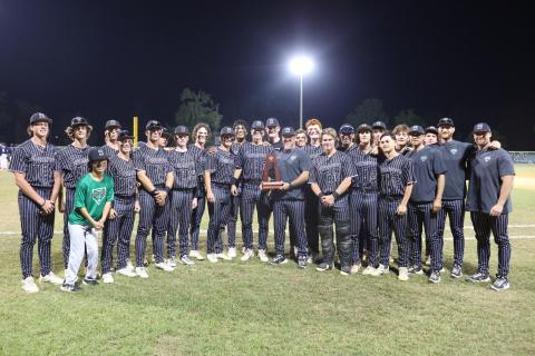 Suwannee's baseball team poses with the District 3-3A trophy after defeating Paxon 10-0 on Thursday. (PAUL BUCHANAN/Lake City Reporter)