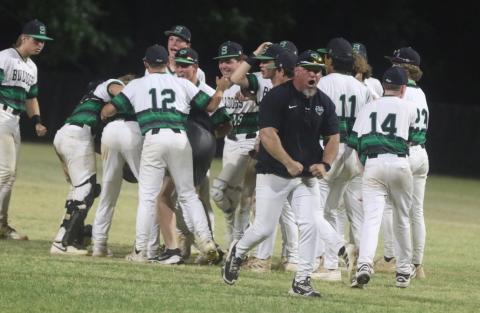 The Suwannee baseball team celebrates with coach Billy Moran out front after the Bulldogs’ 6-5 win over Baldwin in a decisive Game 3 of the Region 1-3A quarterfinals. (MORGAN MCMULLEN/Lake City Reporter)