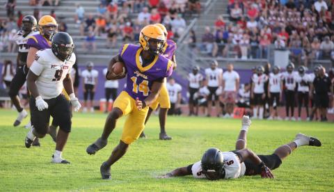 Columbia quarterback Xavier Collins scrambles through the Fort White defense during the teams' spring game on Saturday. (BRENT KUYKENDALL/Lake City Reporter)