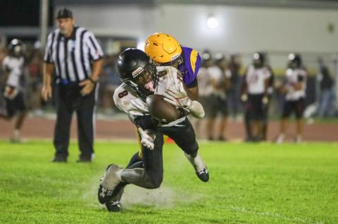 Fort White's Jayden Jackson can't hold on to a catch as he's hit by Columbia defensive back Von Lane during Saturday's spring game. (BRENT KUYKENDALL/Lake City Reporter)