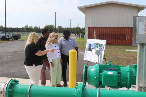 Columbia County Economic Development Director Jennifer Daniels (from left) tells Van Brown and Small Business Administration representatives Tina Davis and Donnie Anderson about tanks and lines at the North Florida Mega Industrial Park wastewater plant during a tour Thursday morning. (TONY BRITT/Lake City Reporter)