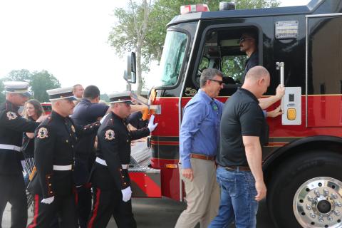Suwannee County Fire Rescue firefighters and county officials take part in the traditional push-in ceremony Thursday to officially welcome Engine 11 into service for the county’s fire service. (JAMIE WACHTER/Lake City Reporter)
