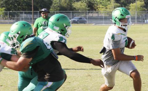 Suwannee quarterback Thomas Sikes scrambles past a defender during Thursday’s practice. (JAMIE WACHTER/Lake City Reporter)