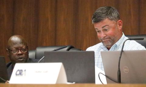 Live Oak Community Redevelopment Agency Chairman Matt Campbell (right) grimaces as he looks over petitions submitted by Board Member Tommie Jefferson (left) in support of a privacy fence around J&W Auto Sales. Jefferson, who collected the petitions on city letterhead, also said during Tuesday’s CRA meeting that he wasn’t seeking any CRA approval. Campbell then asked why was it being discussed at that board’s meeting. (JAMIE WACHTER/Lake City Reporter)