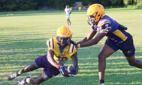 Columbia receiver Kyren Caldwell dives into the end zone past defensive back Vondarius Lane during practice on Wednesday. (JORDAN KROEGER/Lake City Reporter)